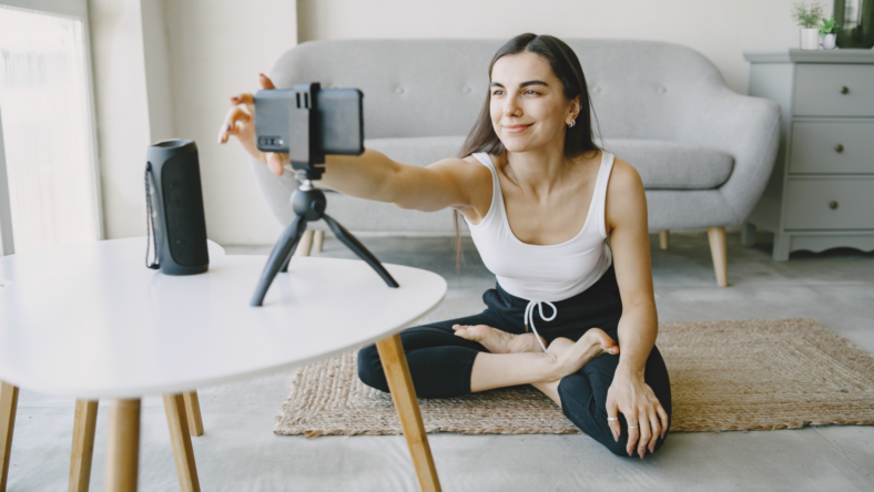 Woman filming self for fitness video