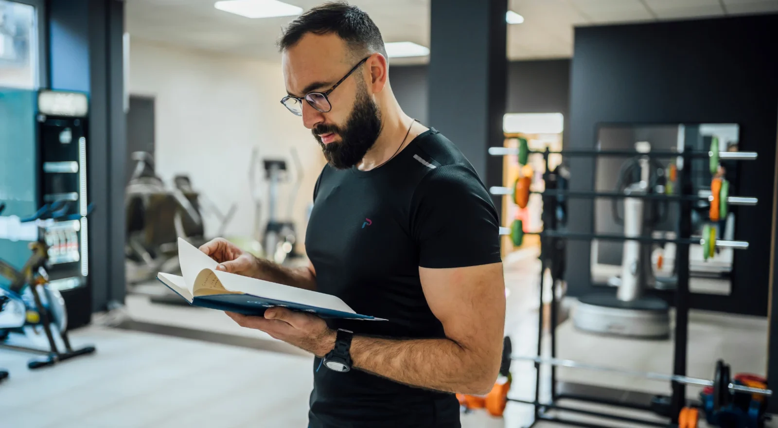 gym owner looking at book