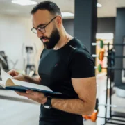 gym owner looking at book