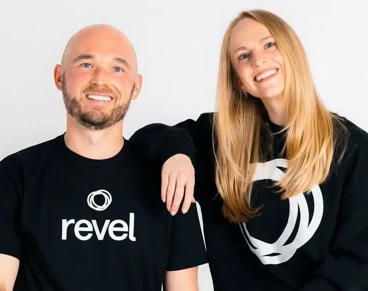 a smiling headshot of Revel owners