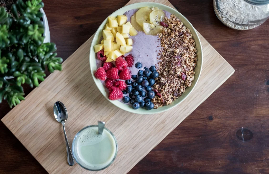 bowl containing fruit, granola and yogurt