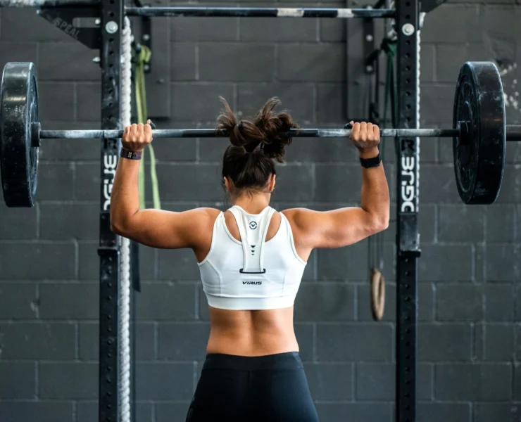 woman performs an overhead press