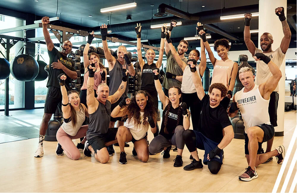 group celebrates at a Mayweather Boxing and Fitness studio