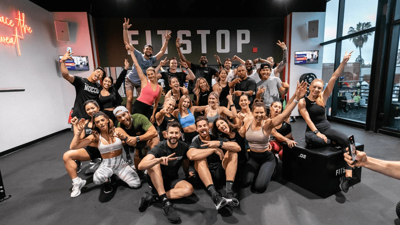 a group of smiling fitness members from Fitstop, a functional fitness franchise