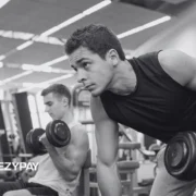 men working out in a gym with dumbbells