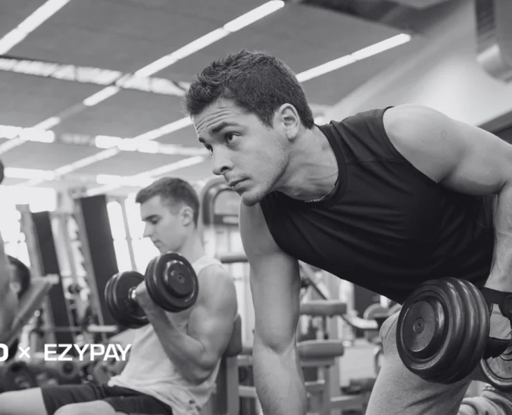 men working out in a gym with dumbbells