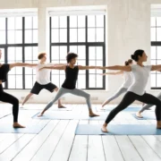 men and woman pose during a yoga class