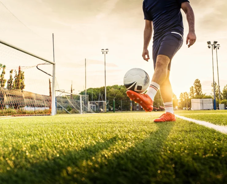 man juggles a soccer ball