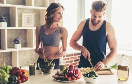 man and woman prepapre healthy food in the kitchen