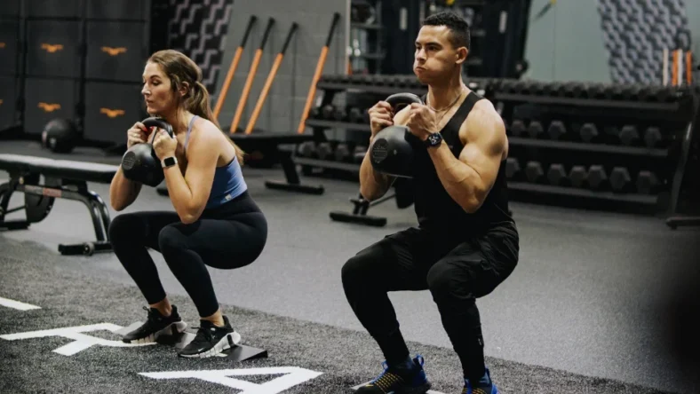 an image of two LA Fitness members working out