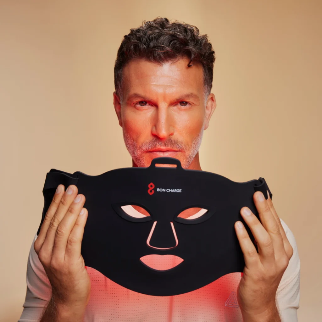 a man with a BON CHARGE red light therapy mask 