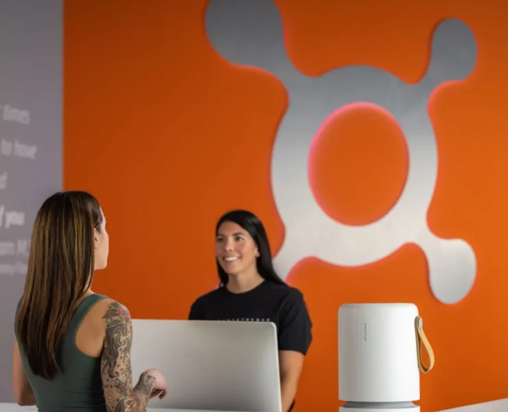 the front desk at Orangetheory with an air purifier from Molekule