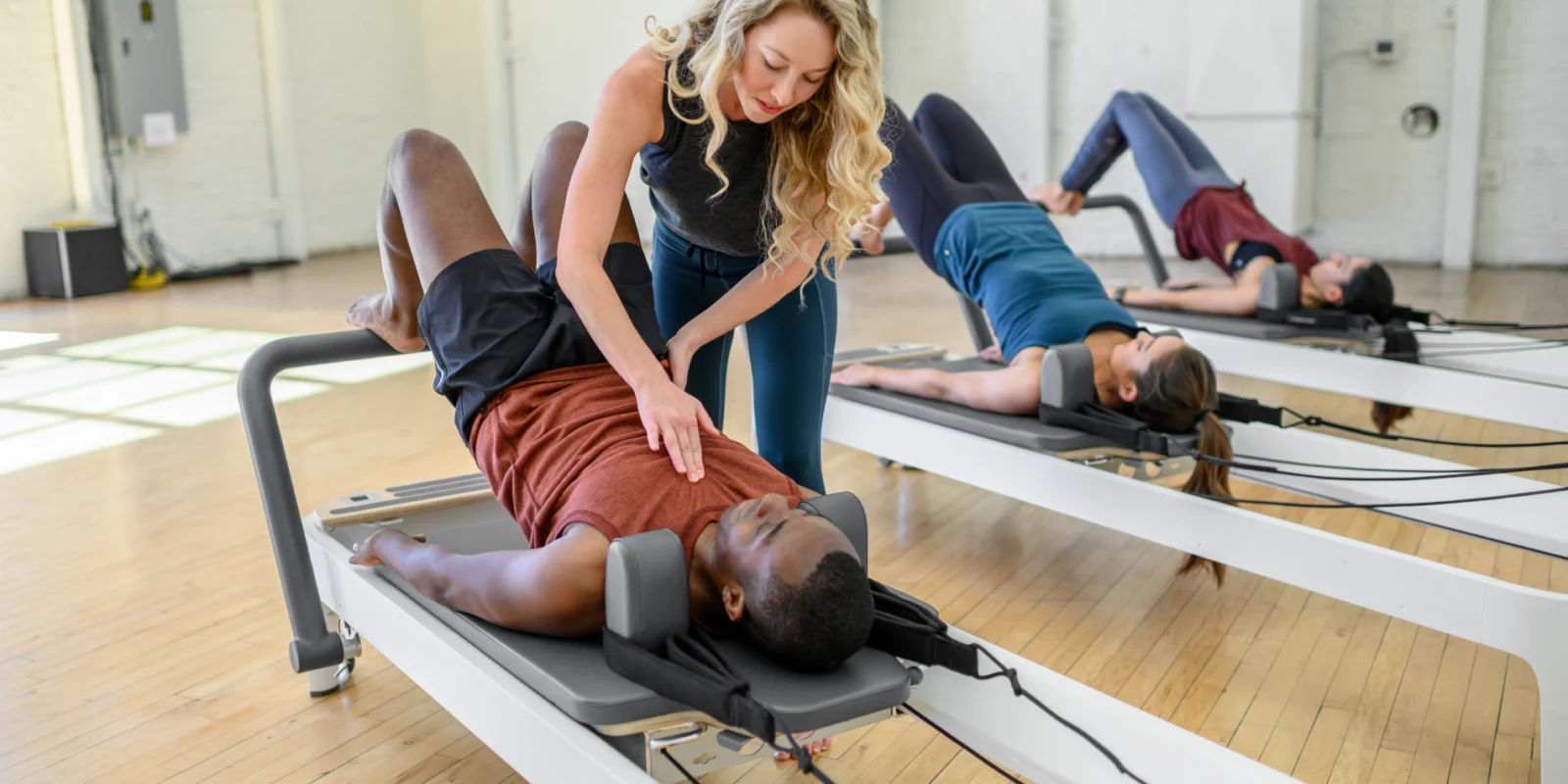 a Pilates instructors assisting a client