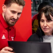 man showing woman how to use fitness app
