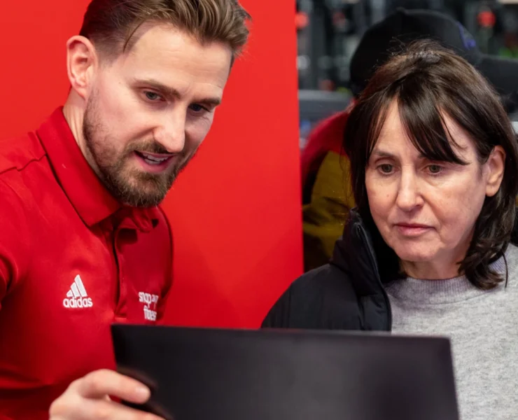 man showing woman how to use fitness app