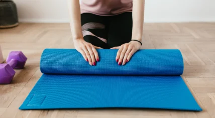 Woman with yoga mat, unrolling