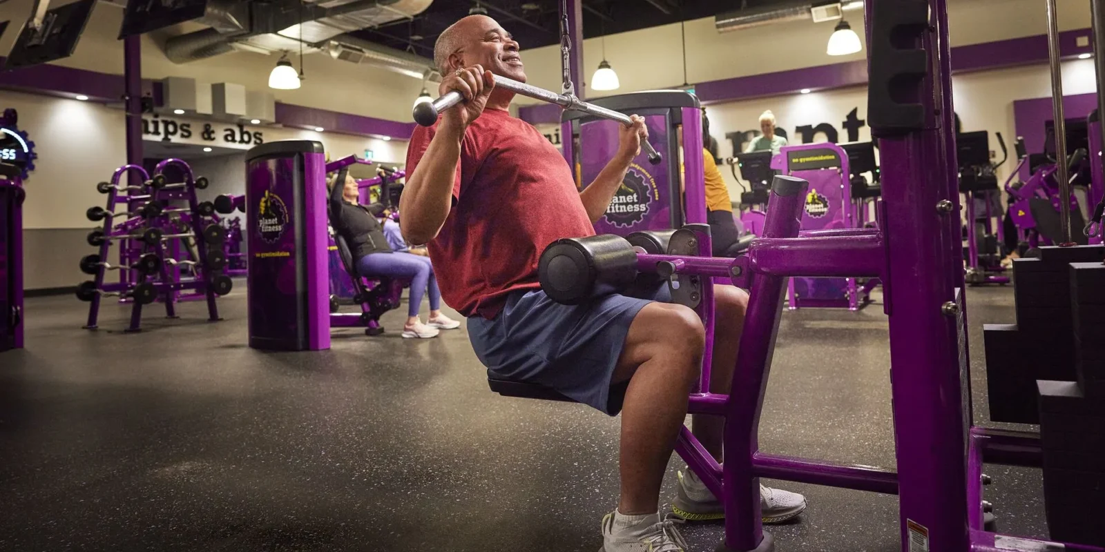 a man strength training at Planet Fitness