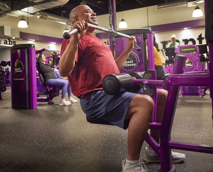 a man strength training at Planet Fitness