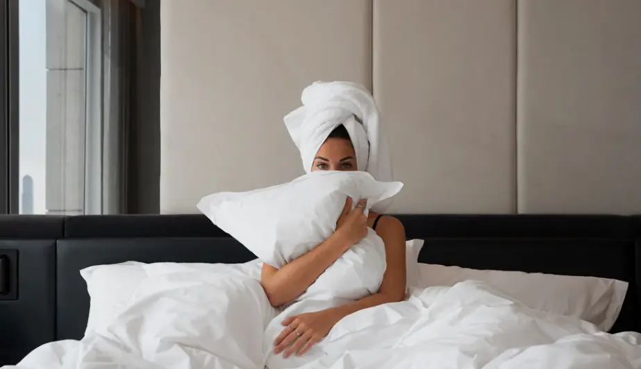 a female guest at Equinox Hotels in bed