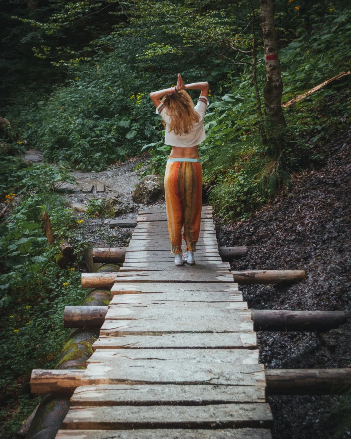 a young wellness seeker in the woods