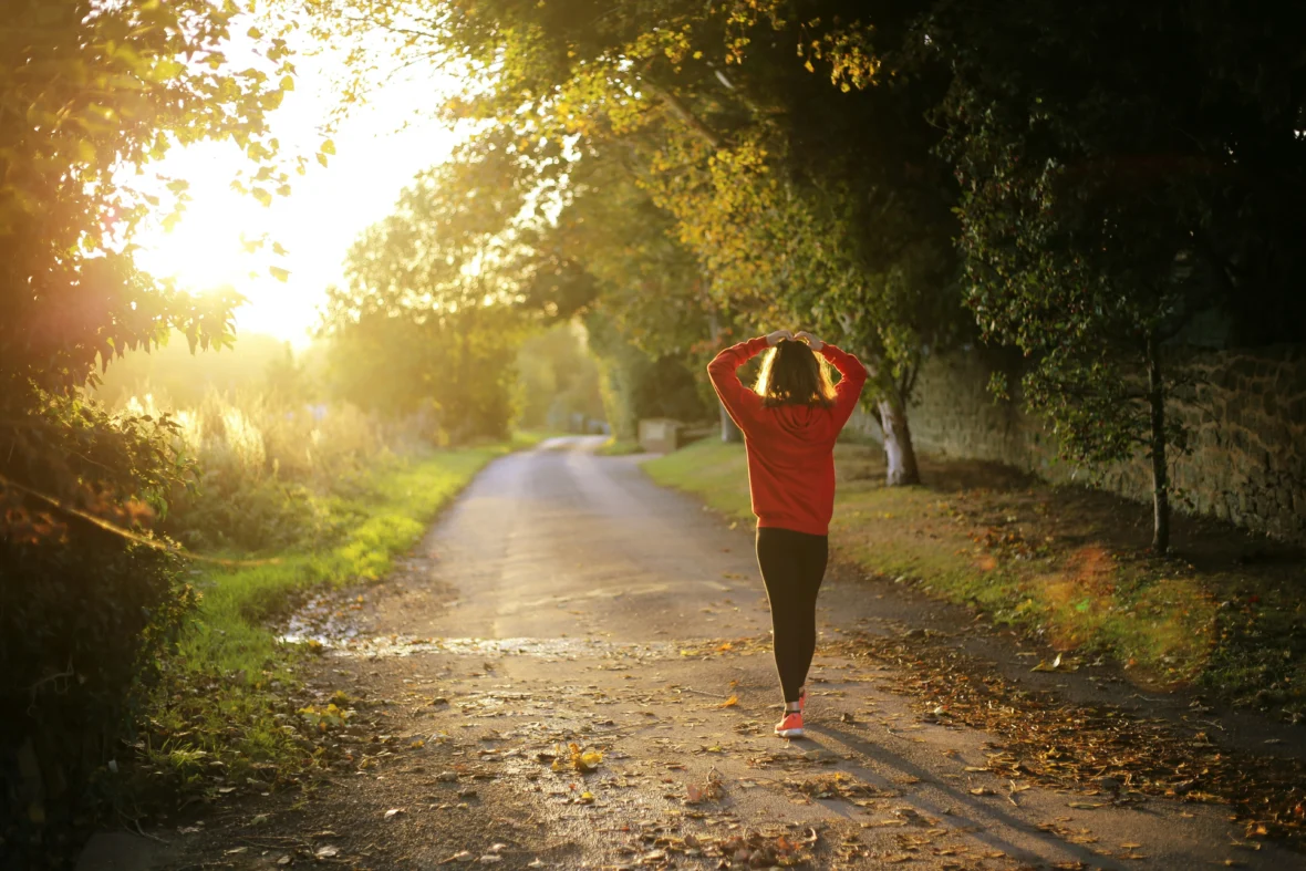 an image of a woman walking outside at dusk/mental wellness