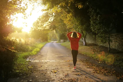 an image of a woman walking outside at dusk/mental wellness