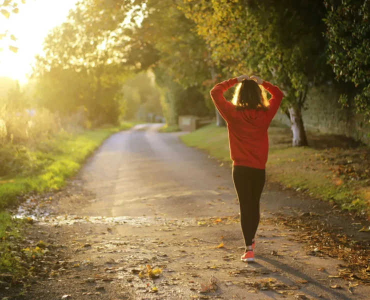 an image of a woman walking outside at dusk/mental wellness