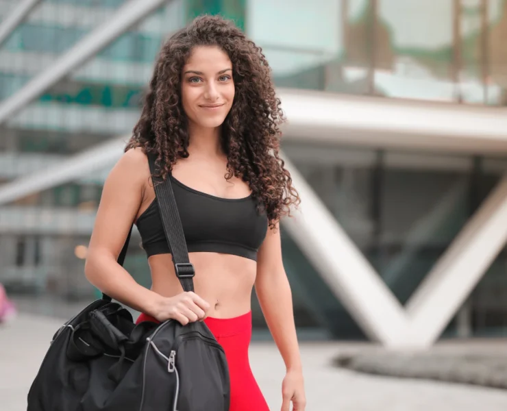 Young woman with gym bag