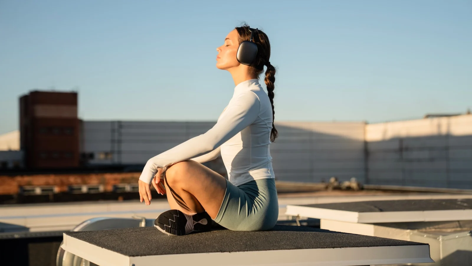 woman meditates with headphones on