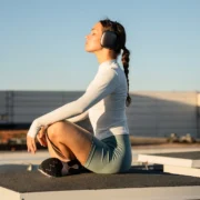 woman meditates with headphones on