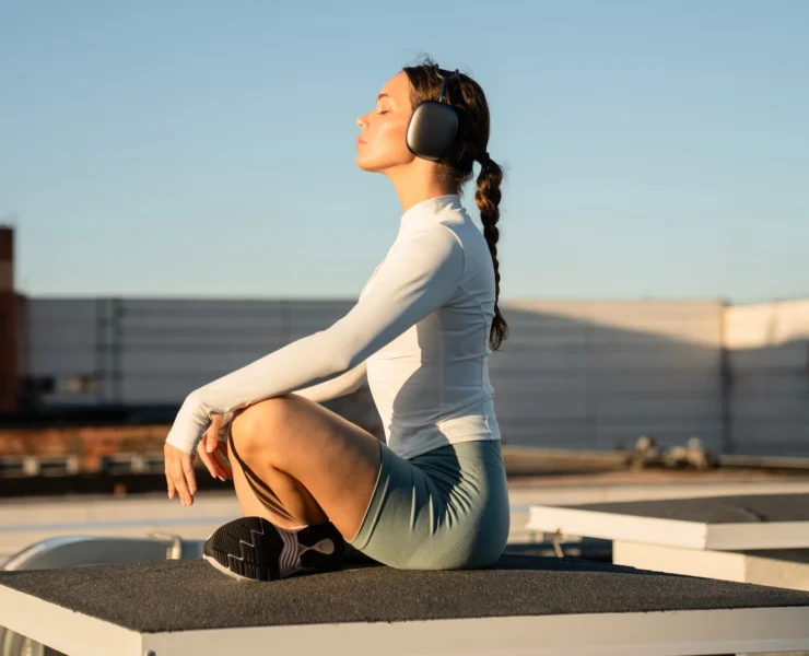 woman meditates with headphones on