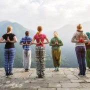 women do yoga overlooking mountains