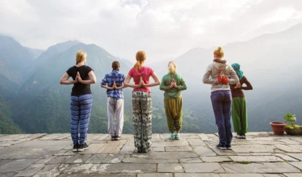 women do yoga overlooking mountains