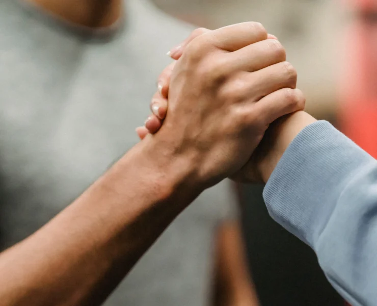 Two people clasping hands