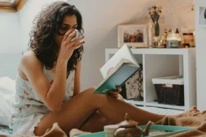an image of a woman reading in bed/health and wellness