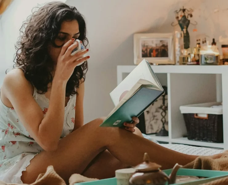 an image of a woman reading in bed/health and wellness