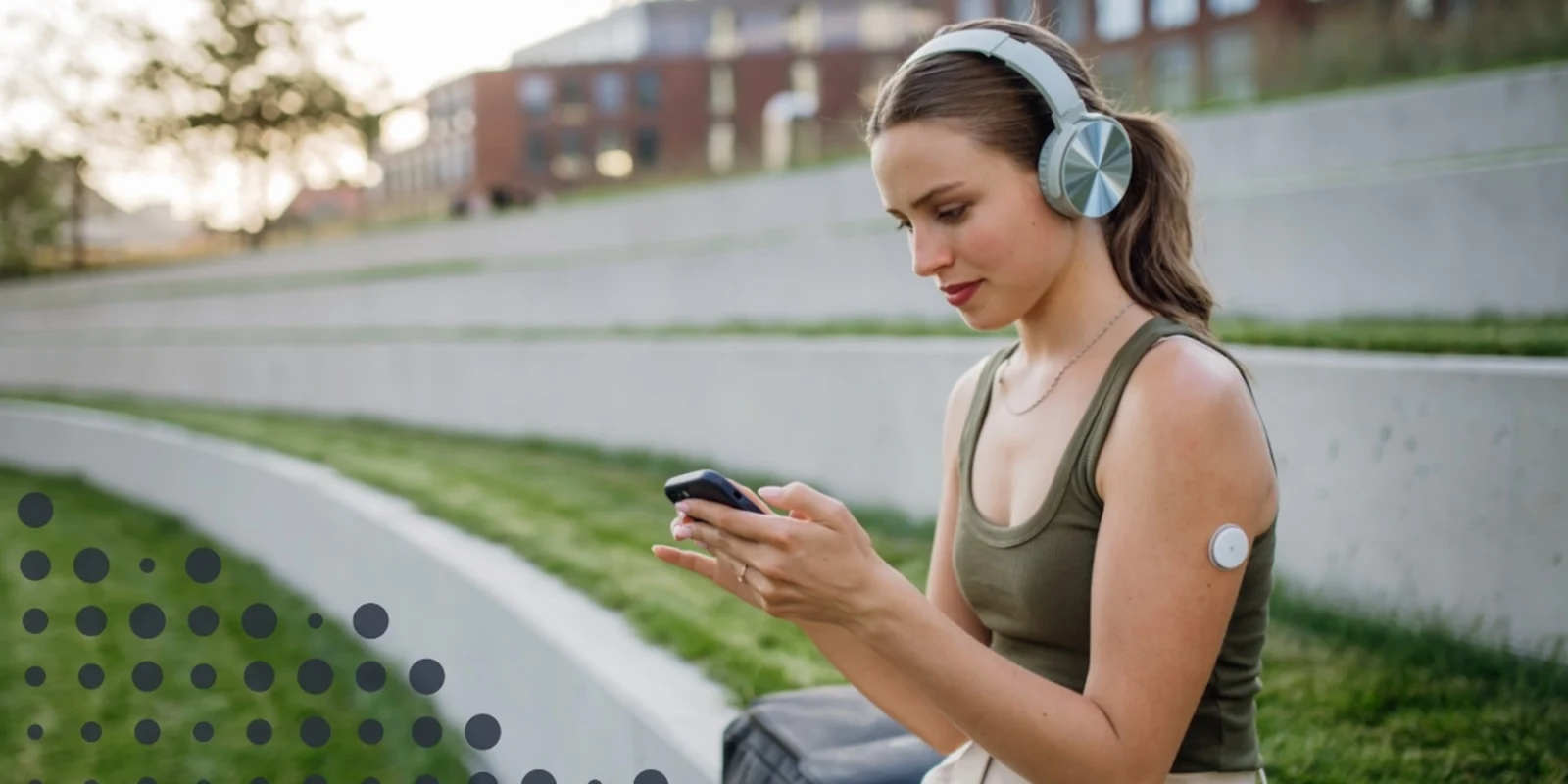 a woman checking the Cronometer app while wearing a CGM