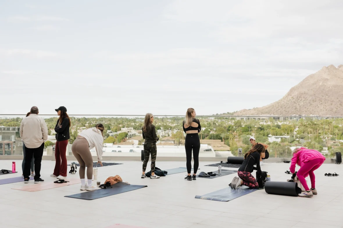women work out overlooking mountains