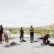 women work out overlooking mountains