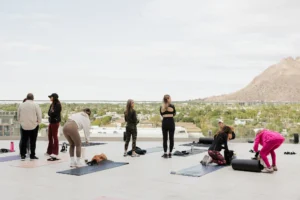 women work out overlooking mountains
