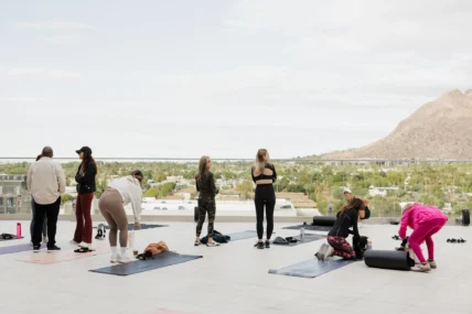 women work out overlooking mountains