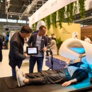 Person trying wellness equipment at trade show
