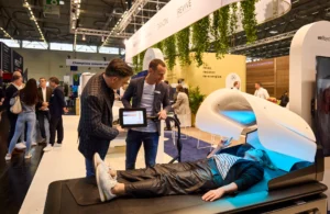 Person trying wellness equipment at trade show