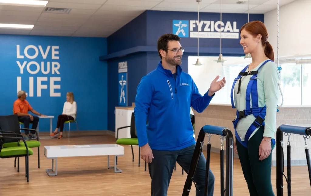 woman speaks with her PT during a physical therapy visit