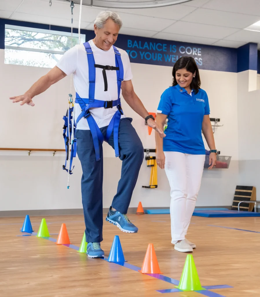 man walks next to a PT during a physical therapy visit