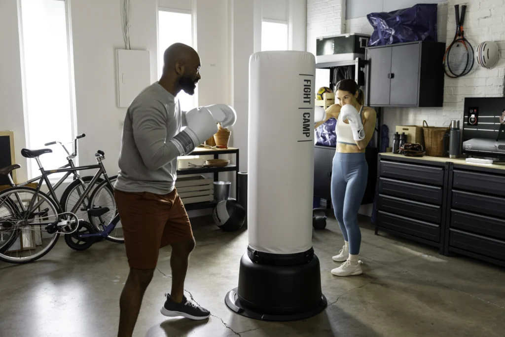 man and woman workout on a FightCamp boxing bag