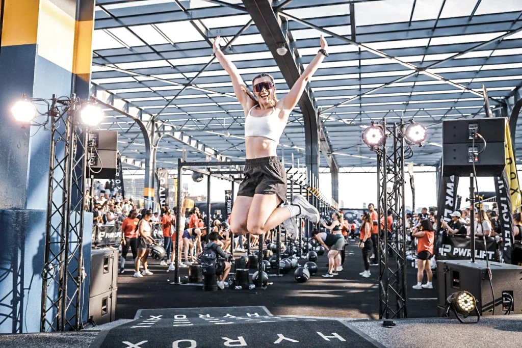 woman celebrates at a Hyrox race in New York City