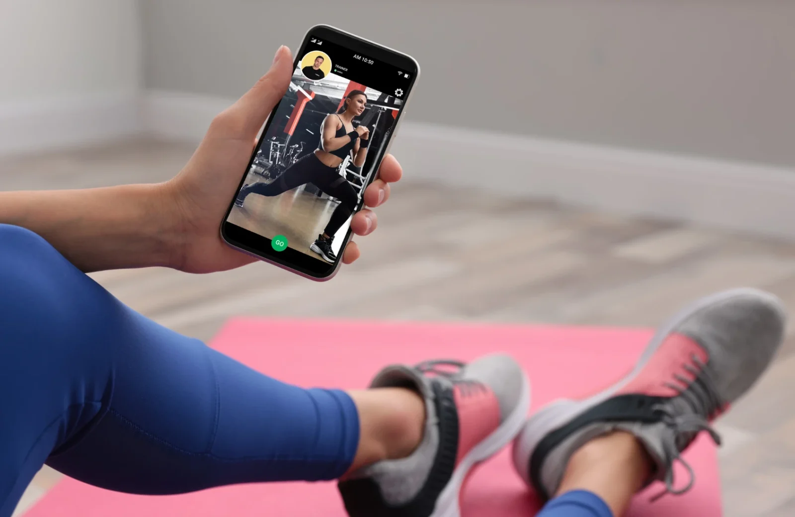 Woman working out with trainer on smartphone