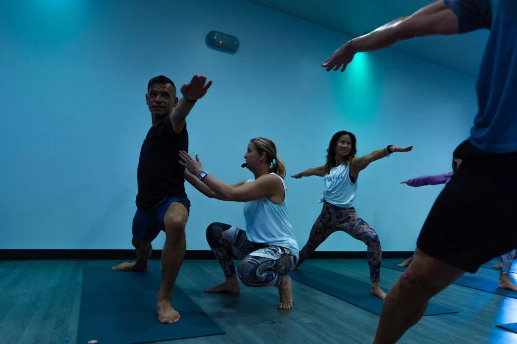 men and women inside a yoga studio