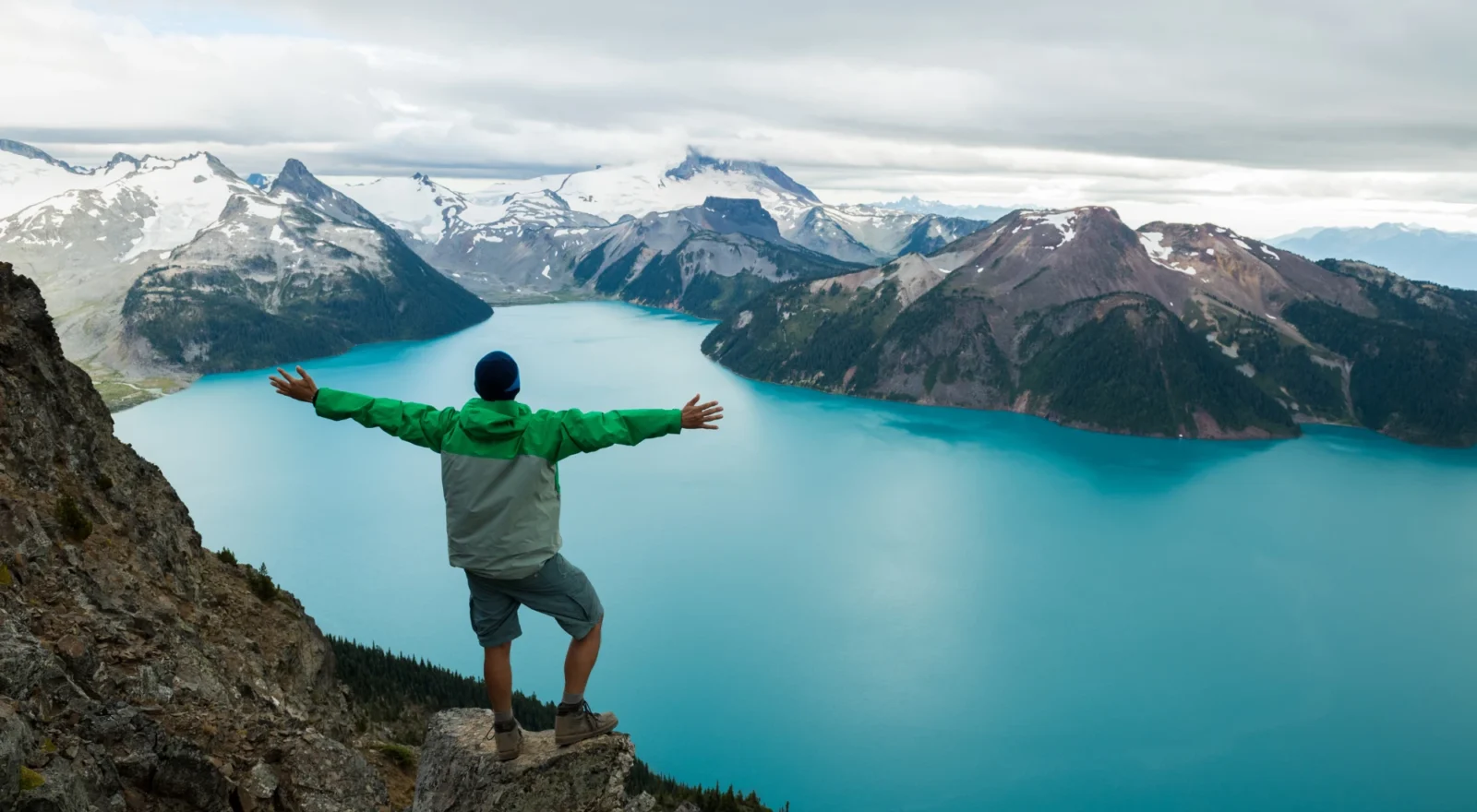 Man outside looking at mountain scene